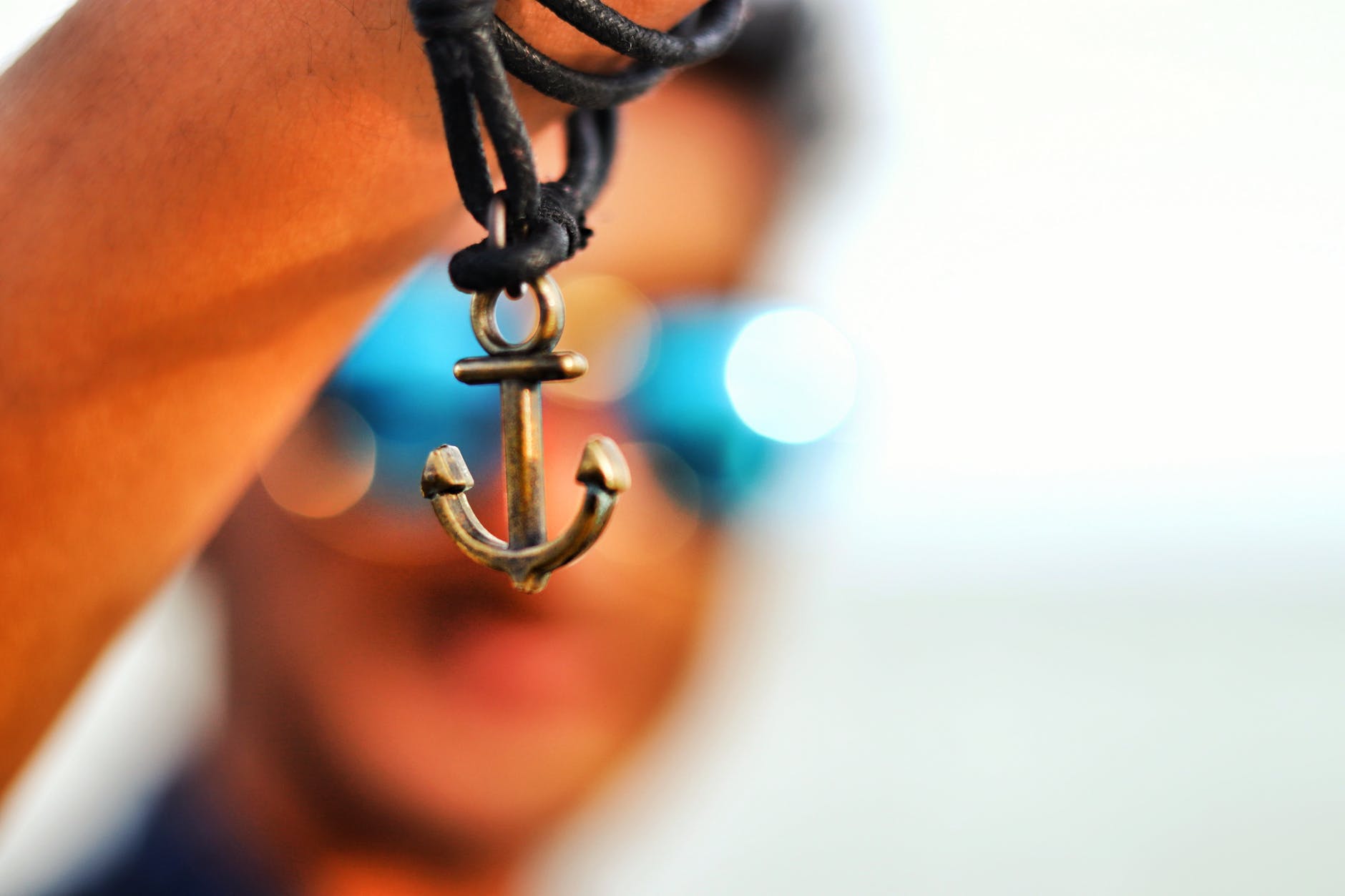 selective focus photography of anchor pendant